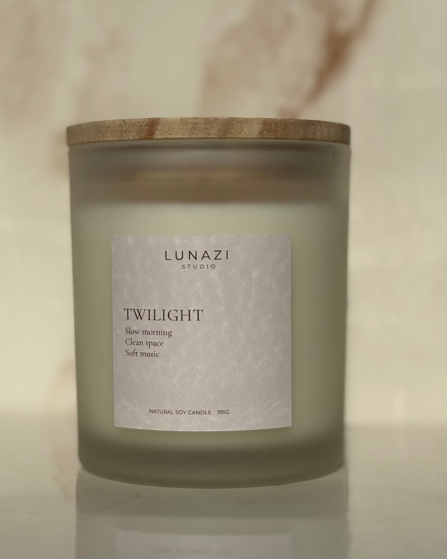 Lunazi Studio luxury frosted glass Twilight candle with a wooden lid on a neutral background