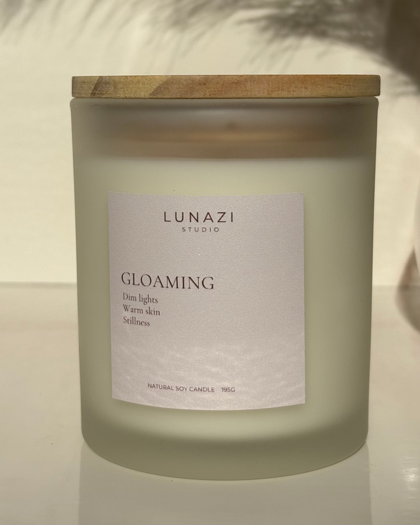 Gloaming Scented Candle by Lunazi Studio – close-up of frosted candle jar with Lunazi label and wooden lid