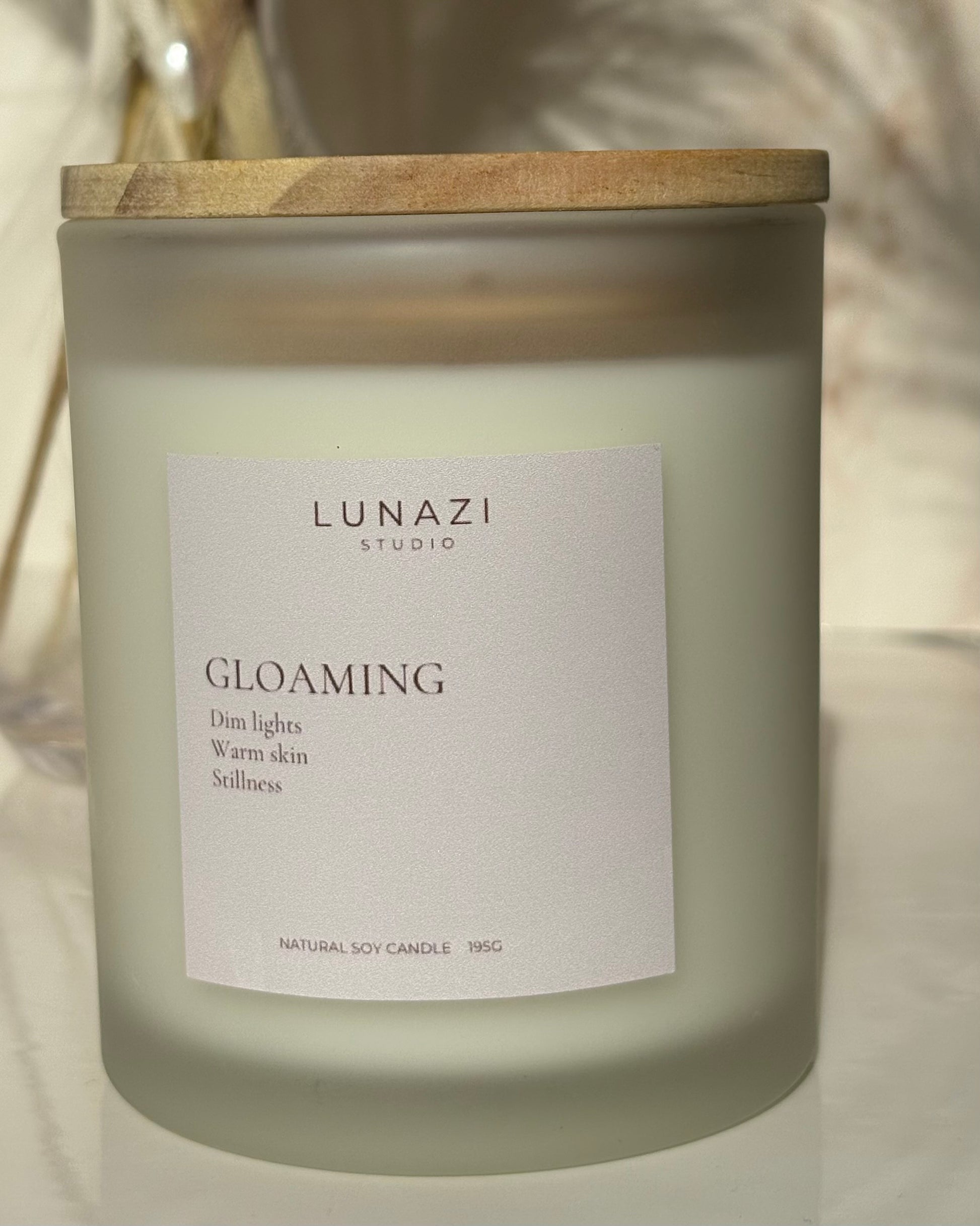 Gloaming Scented Candle by Lunazi Studio – styled candle shot with warm ambient lighting