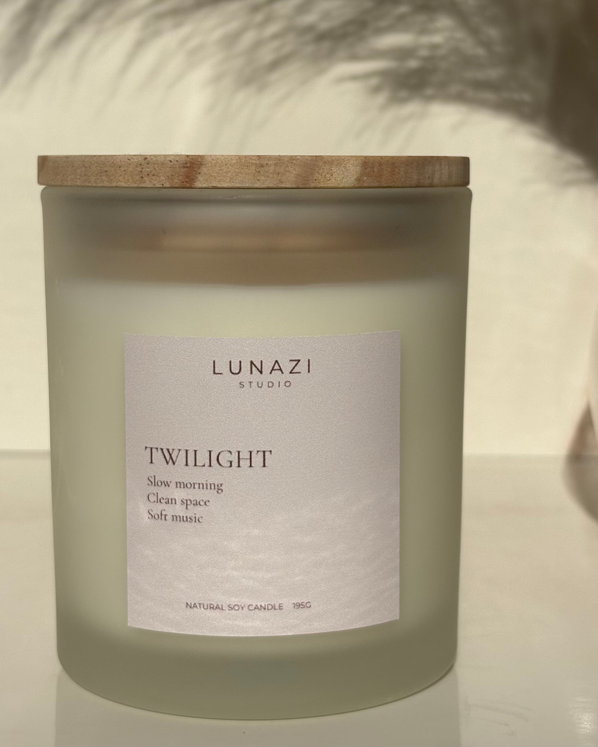 Lunazi Studio frosted candle labeled 'Twilight' with a wooden lid on a neutral background